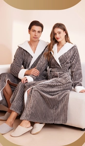 Detail of dark grey striped flannel robe featuring white fleece lining on the hood and cuffs
