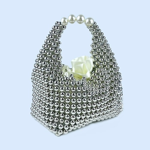 Detailed shot of handmade silver beaded pillow bag with elegant pearl-style handle