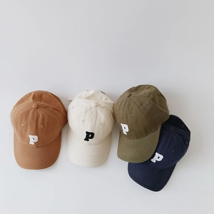 Flat lay view of kids baseball caps in four colors featuring embroidered P letter