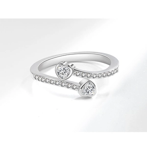 Macro shot of silver heart ring with zircon inlay and sparkling wrap-around diamonds