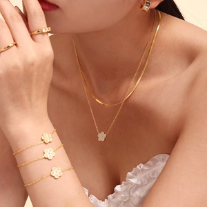Gold-plated clover jewelry set with zircon necklace, bracelet, and earrings on model