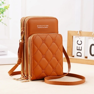 Detail view of brown quilted PU leather phone bag featuring three gold zippered pockets