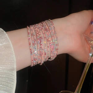 Detail of multi-layered pink crystal stretch bracelet on model in elegant setting