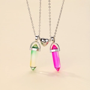 Macro shot of magnetic heart clasp connecting pink and green crystal necklaces