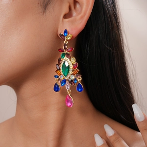 Detailed close-up of luxurious multi-color gemstone drop earrings worn by a model