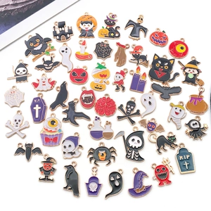 Detailed view of Halloween enamel charms featuring pumpkin ghost and bat designs