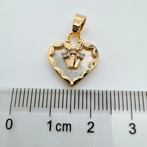 18K gold-plated heart pendant with shell inlay and crown detail measured on a metric ruler