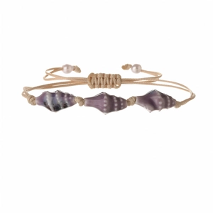 Detail of woven bracelet with purple seashell charms and white pearls on cream cord