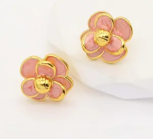 Detail view of pink enamel camellia earrings with gold trim, size 19mm and weight 12.2g