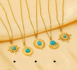 Detail of five bohemian turquoise sunburst pendants on warm yellow silk fabric