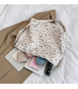 Detail view of floral tote bag showing large capacity for tablet and daily items