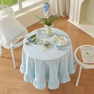 Detail of light blue ruffled lotus edge on vintage cotton tablecloth for home decor