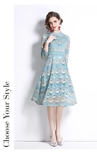 Close-up of elegant light blue lace embroidery with scalloped pattern on A-line dress