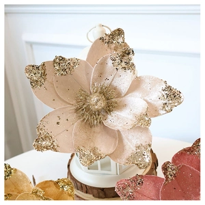 Close-up of champagne velvet artificial flower with golden glitter edges for Christmas decor