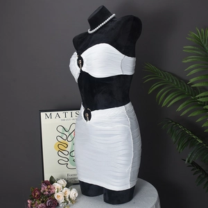 Detail of white two-piece set featuring textured wavy fabric and gold metal ring hardware