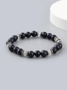 Men's blue goldstone beaded bracelet with silver spacers on a grey background