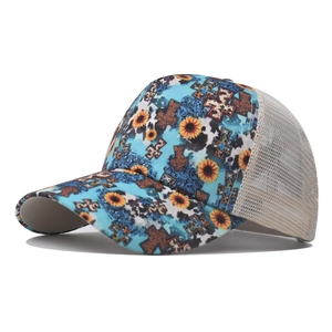 Detail of sunflower and cross print on mesh ponytail baseball cap at a side view angle