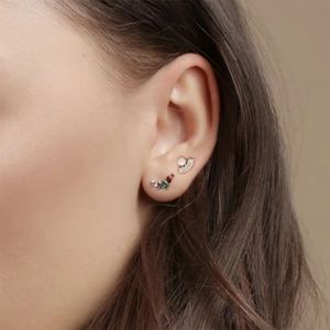 Detail of model wearing S925 silver wing earrings with colorful zircon and gold finish