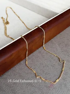 Close-up of 18k gold plated titanium steel necklace with textured rectangular links
