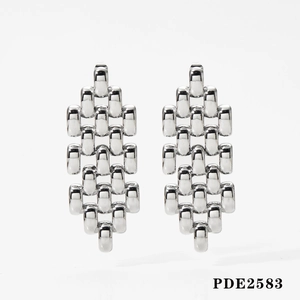 Detailed macro view of silver geometric chain earrings with polished finish and high gloss