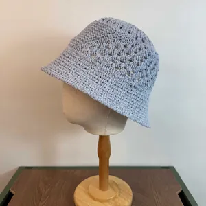 Close-up of light blue hollow crochet pattern on breathable knit bucket hat for women