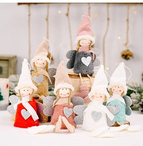 Detail of colorful plush Christmas angel ornaments with sequins and knitted hats