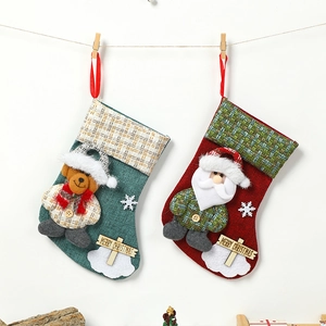 Linen Christmas stockings with Santa and bear wooden tags hanging on a line decoration