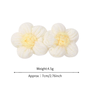 Children knit daisy flower hair clip measuring 7cm in off-white and soft yellow hues