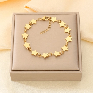 Close-up of gold star chain bracelet with interlocking metal charms and lobster clasp