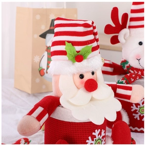Close-up of Santa and reindeer plush Christmas candy bags with knitted textures