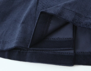 Detailed view of the dark blue corduroy hem with clean overlock and double needle stitching