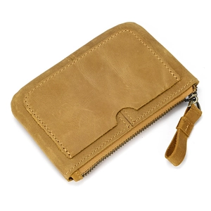 Detail of a brown leather coin purse showing smooth stitching, card slot and zipper