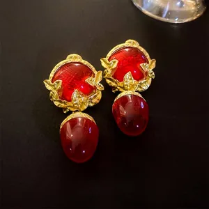 Vintage palace style earrings with ruby red resin drops and gold leaf accents