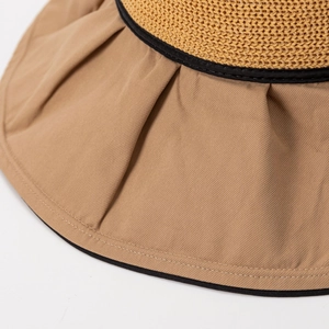 Women's summer straw sun hat with wide brim, black ribbon trim and chic bow detail