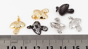 Macro detail of cubic zirconia mushroom pendant charm with ruler showing 12mm width