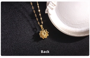 Detailed back view of golden rotating four-leaf clover pendant with fine chain link