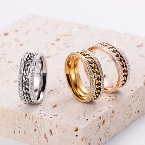 Three twisted chain knot rings with zirconia stones in silver, gold, and rose gold finishes