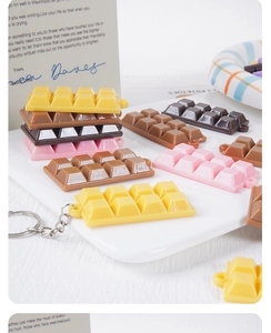 Detailed view of realistic chocolate resin keychains with metallic foil 3D textures