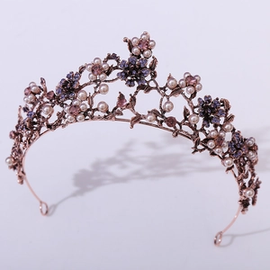 Detail view of vintage bronze bridal crown with purple rhinestones and pearls