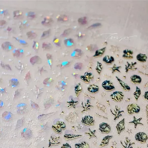 Macro view of 3D embossed marine nail stickers with gold shell and starfish designs