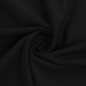 Macro della trama del tessuto a maglia nero che mostra la morbida caduta e la qualità superiore