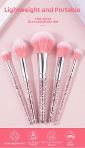 Close-up of pink diamond-handle makeup brushes with soft gradient synthetic bristles