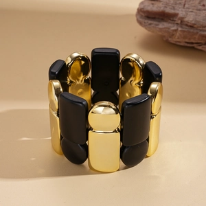 Modern stretch bracelet with black and gold acrylic and polished metal geometric modules