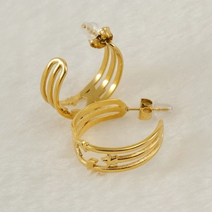 18K gold plated stainless steel star and moon hoop earrings on white plush background