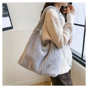 Macro detail of plush shoulder tote bag in grey showing soft texture and large capacity