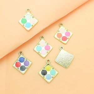 Detailed close-up of square alloy enamel charms with colorful four-grid design patterns