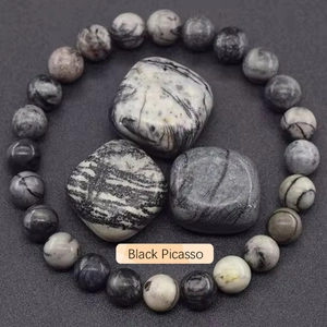 Macro shot of Black Picasso Jasper beaded bracelet with natural raw stones in grey tones