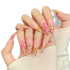Pink press-on nails featuring red marble patterns and metallic 3D cross charms