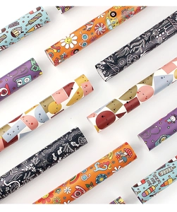 Detail view of assorted cartoon gift wrapping paper rolls with vibrant animal patterns