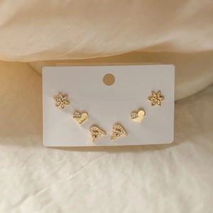 Detailed view of 18K gold-plated heart earrings with LOVE engraving and zircon flower set